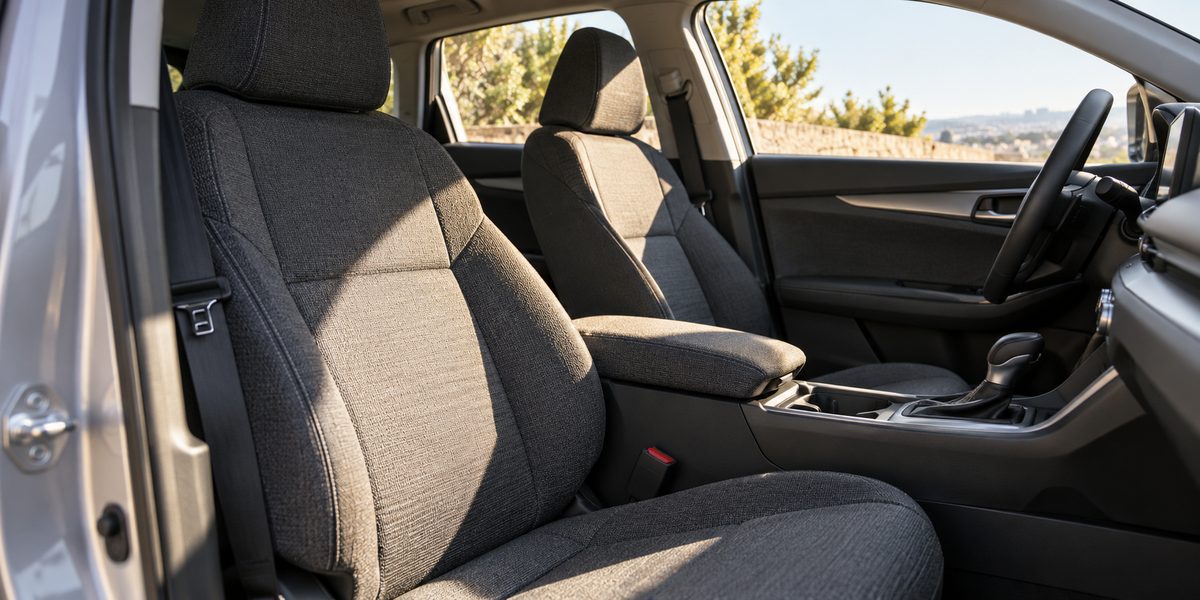 Sunlight across the woven textile seats of an unbranded car